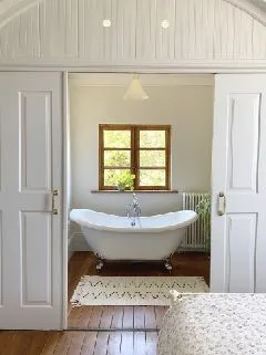 A freestanding bathtub in an ensuite bathroom