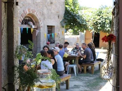 Guests sharing a meal in the stone courtyard