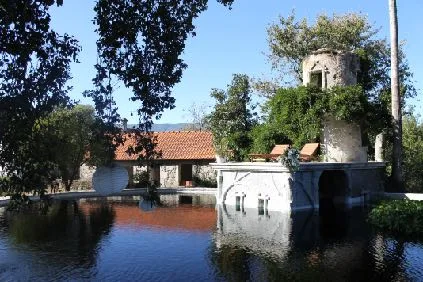 The natural lake and swimming pool beside the old stone buildings